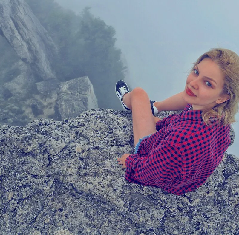 Girl Sitting On The Tskhrajvari Cliff 2 days of pure hike – a group tour from Tbilisi
